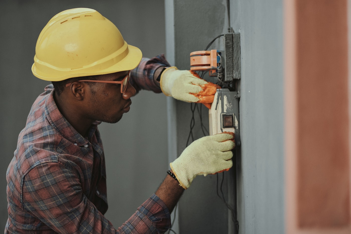 HVAC technician servicing a home furnace while explaining the work to the homeowner